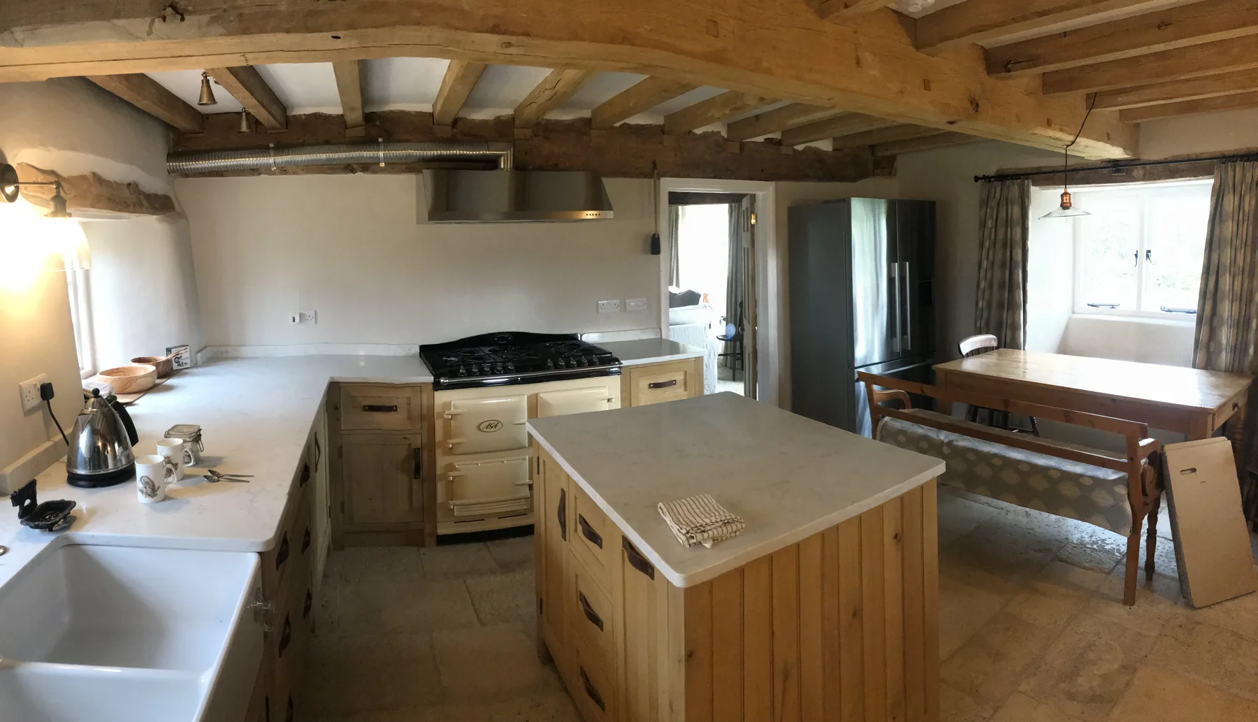 Renovated interior with exposed timber beams and kitchen